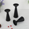 black-minimalist-candle-holder-set-table-display Matte black conical candle holder set without candles, linen table decor with red berries and greenery