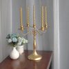 Gold 5 head candelabra with lit twisted taper candles dining table home decor