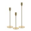 Set of 3 glossy gold modern taper candle holders, isolated white background