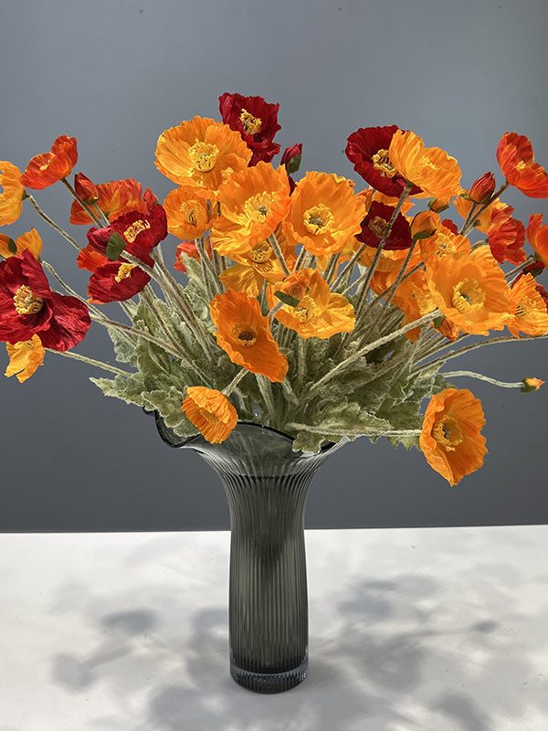 Mixed color flocked iceland poppy artificial flowers arranged in glass vase, home floral display